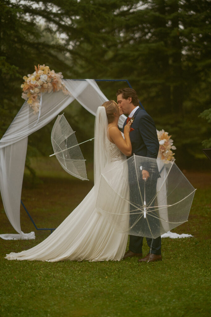 Edson Alberta Wedding in the rain, first kiss in the rain wedding photo