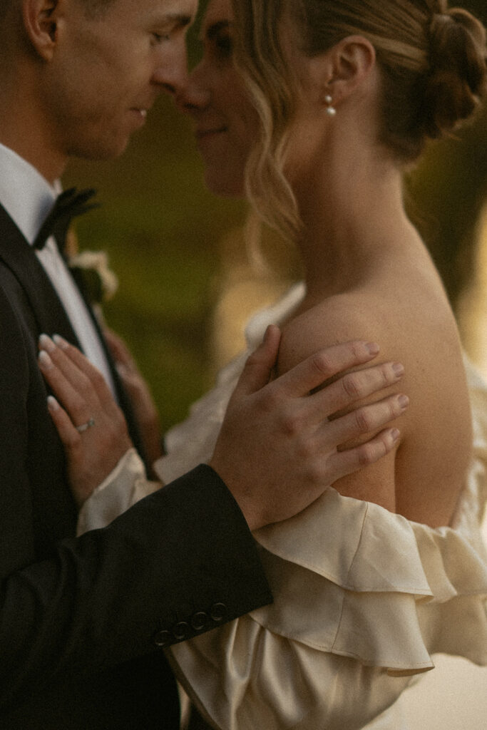 Closeup photo of bride and groom cuddling in Jasper National Park