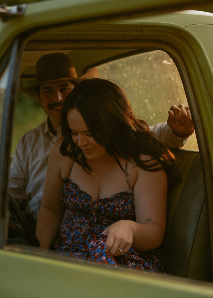 Western Photoshoot of a Couple sitting in a green ford truck in Edson Alberta