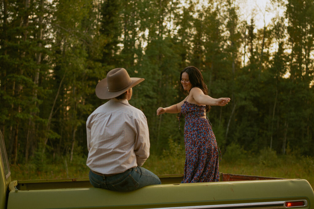 Cute Western Couple Dancing in the Truck Box of an old Green Ford