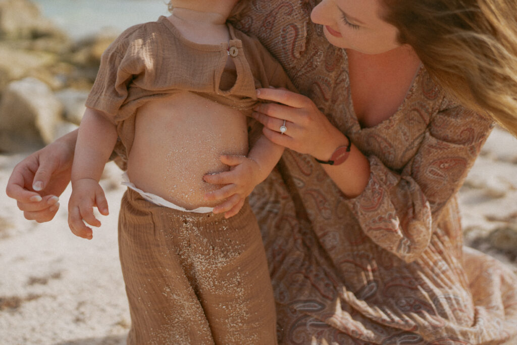 candid photo of mother and son on the beach