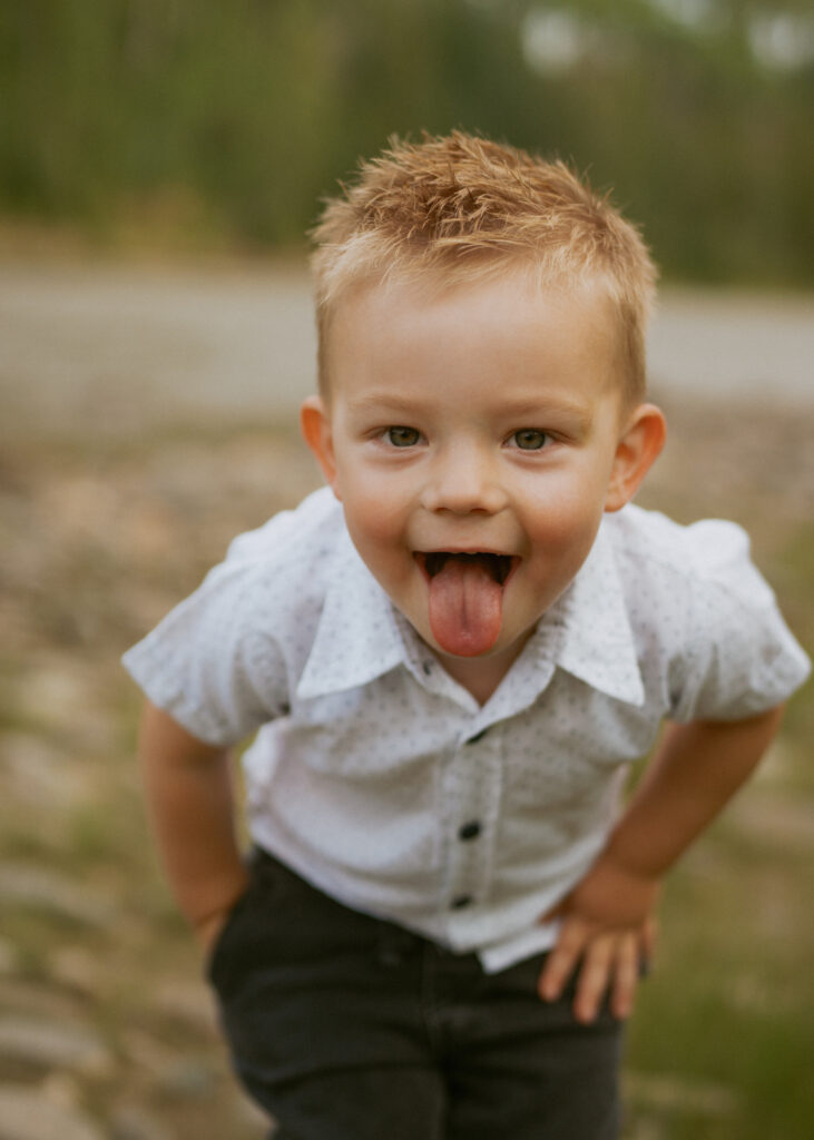 silly photo young boy sticking tongue out for photo