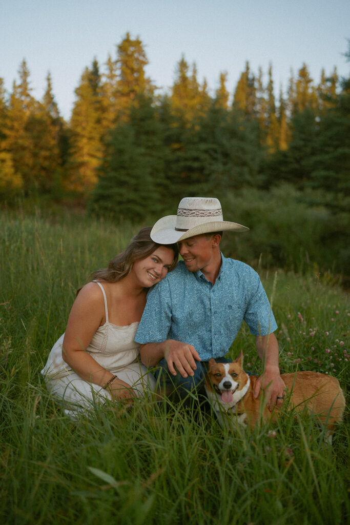 couple posing for a photo with their dog