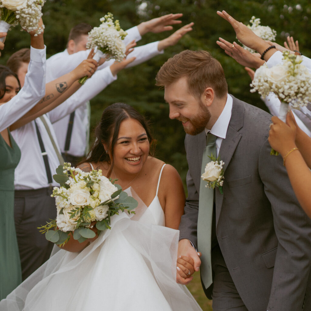 Just married couple celebrating with their bridal party at their Hinton Alberta wedding.