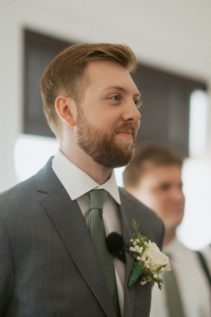 Groom watching his bride walk down the aisle at their Hinton Alberta wedding.