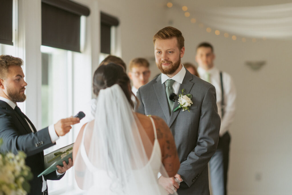 Groom watching his bride walk down the aisle at their Hinton Alberta wedding.
