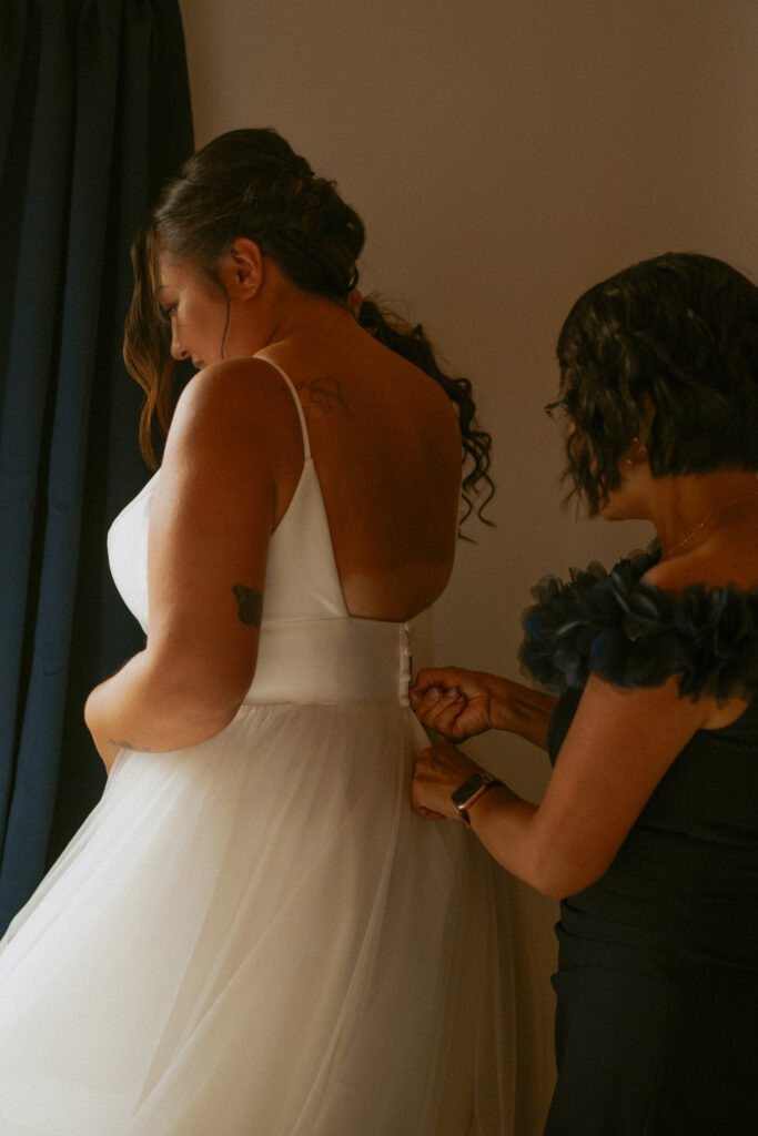 Mother helping the bride get ready before her Hinton Alberta wedding.