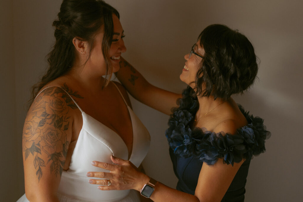 Mother helping the bride get ready before her Hinton Alberta wedding.