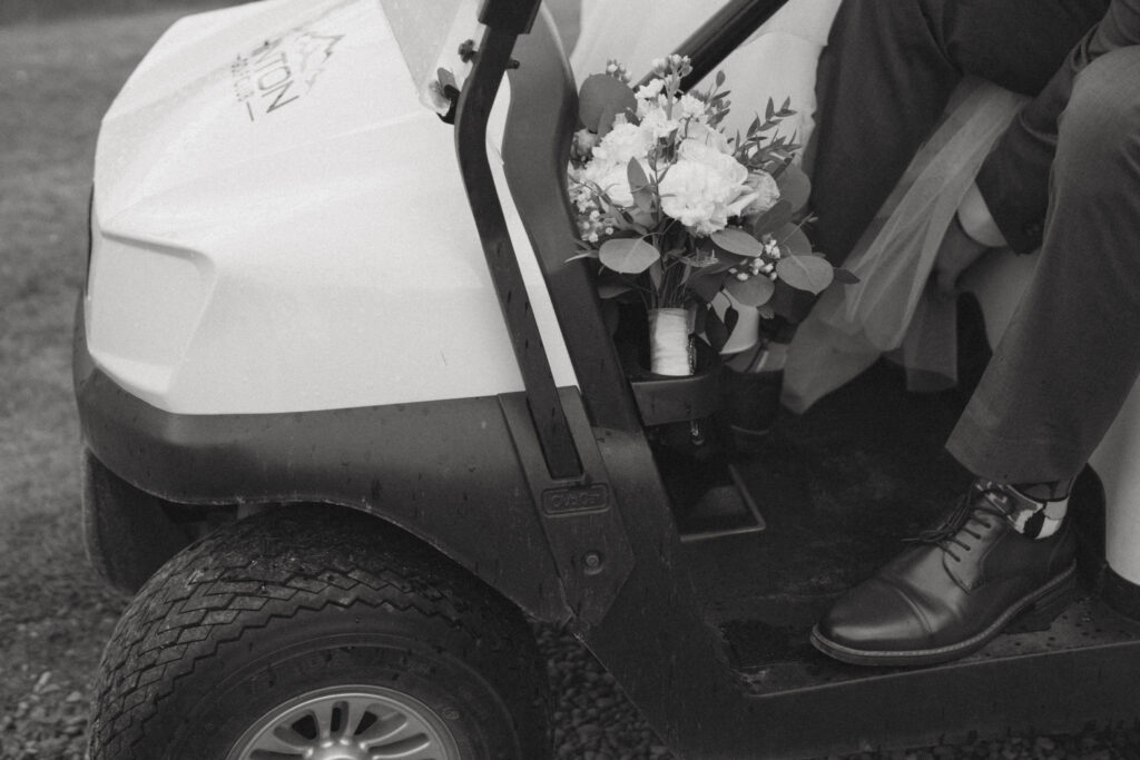 Newlyweds riding a golf cart at their Hinton Alberta wedding.
