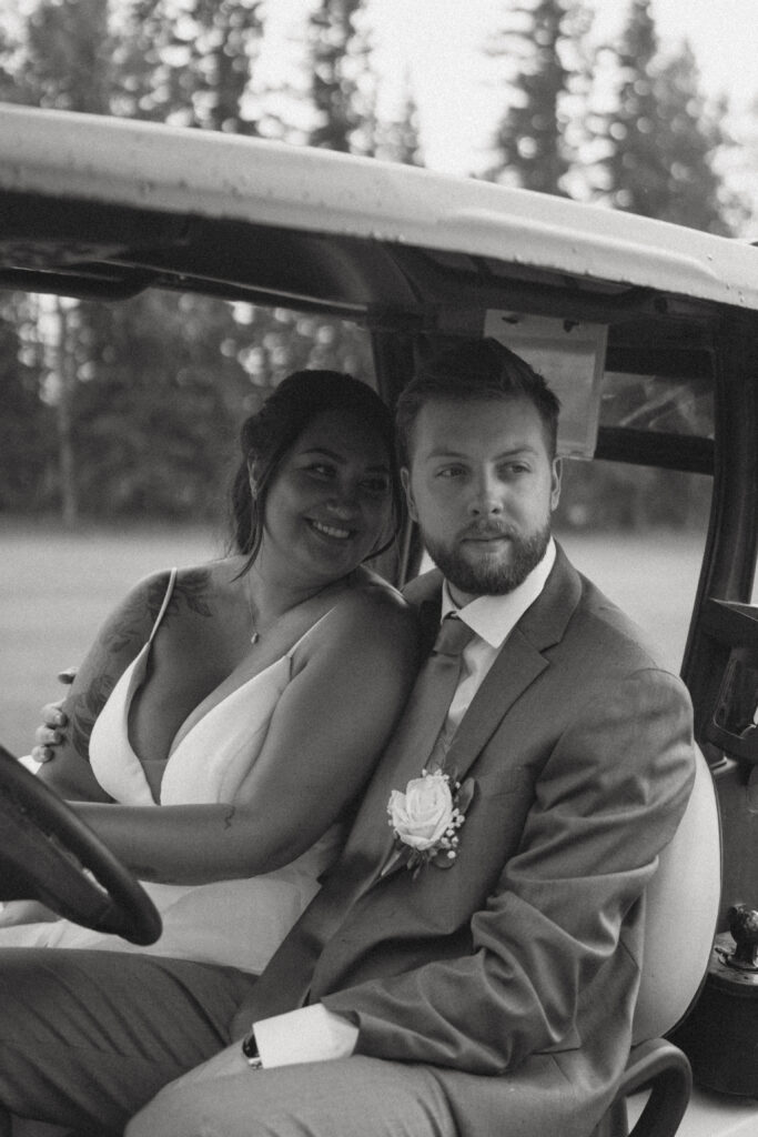Newlyweds riding a golf cart at their Hinton Alberta wedding.