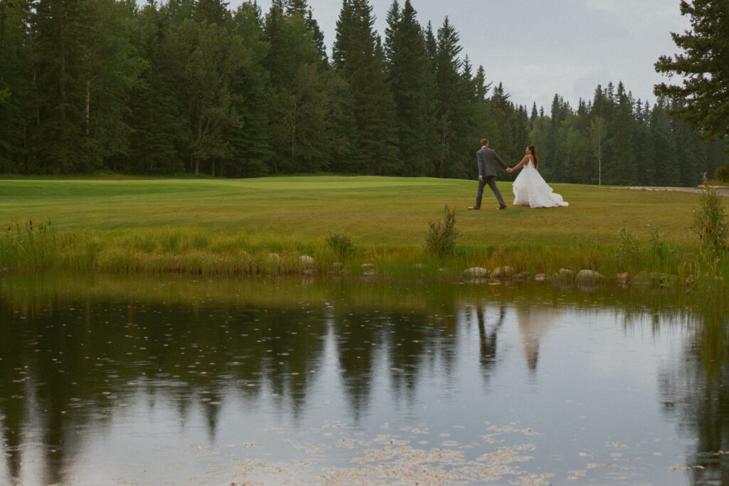 Peaceful moment by the pond at a Hinton Alberta wedding.