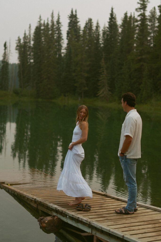 Carefree dockside moment captured by Edmonton wedding photographer.