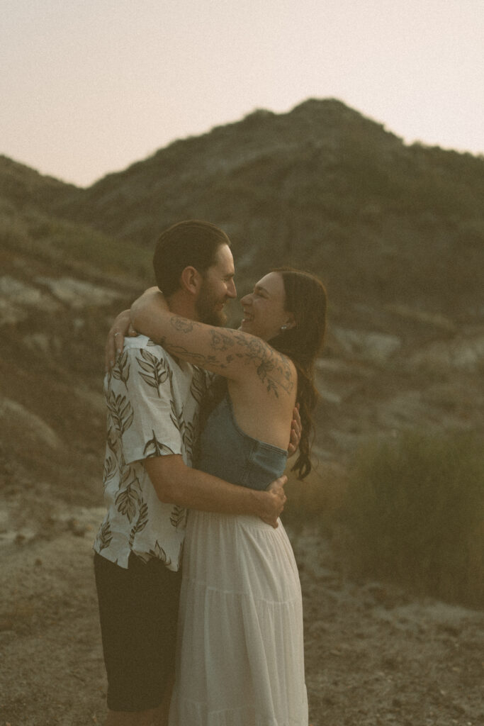 Joyful couple’s embrace at sunset in the Alberta badlands by Drumheller wedding photographer.
