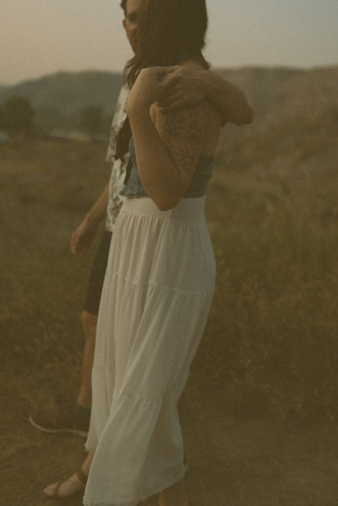 Tender detail shot of couple in golden hour light by a Drumheller wedding photographer.