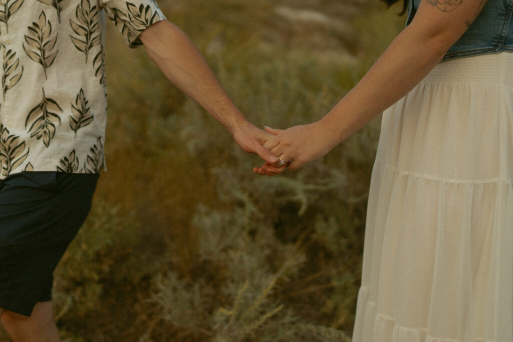 Tender detail shot of couple in golden hour light by a Drumheller wedding photographer.