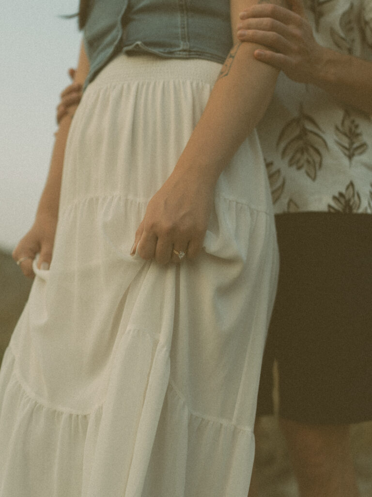 Tender detail shot of couple in golden hour light by a Drumheller wedding photographer.