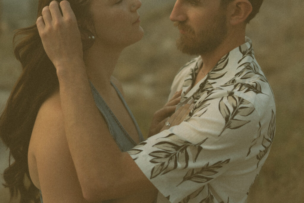 Tender detail shot of couple in golden hour light by a Drumheller wedding photographer.