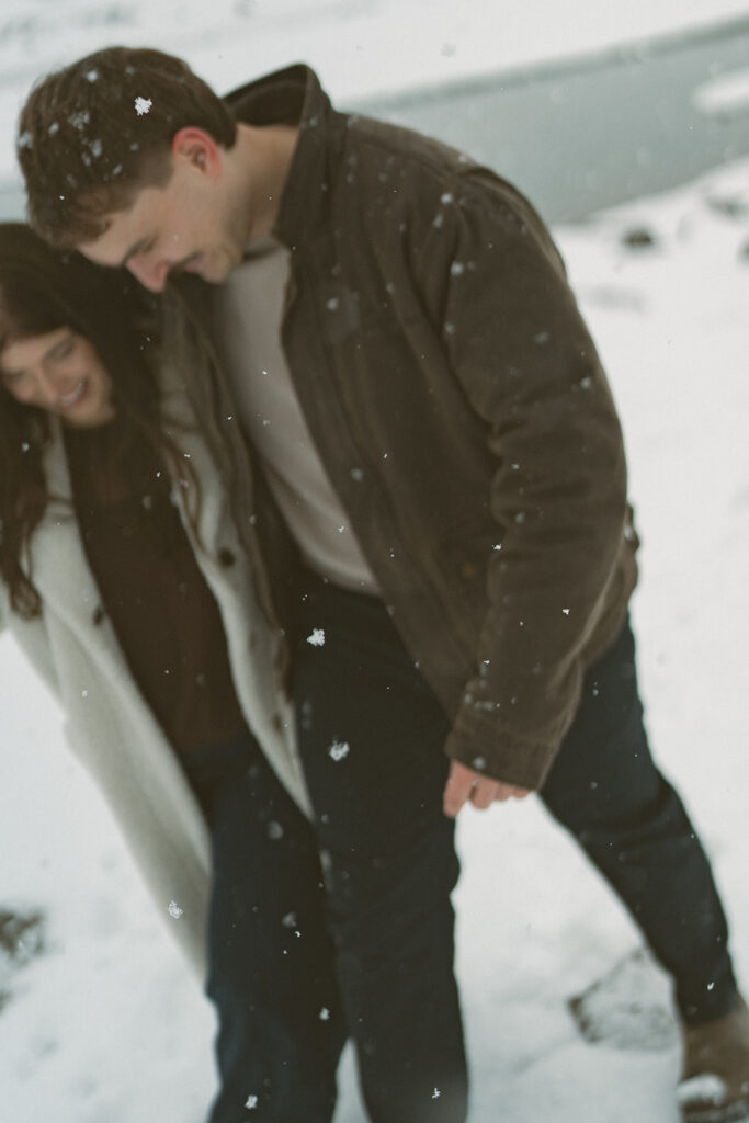 Documentary style engagement session in snow at Medicine Lake