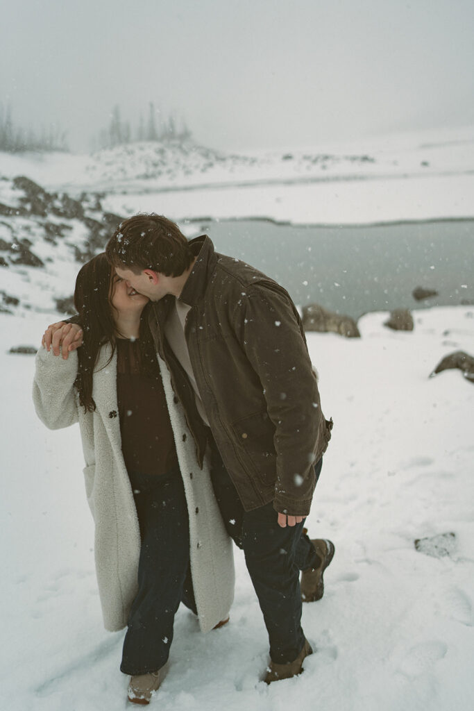Romantic candid engagement photos in Jasper National Park snowstorm