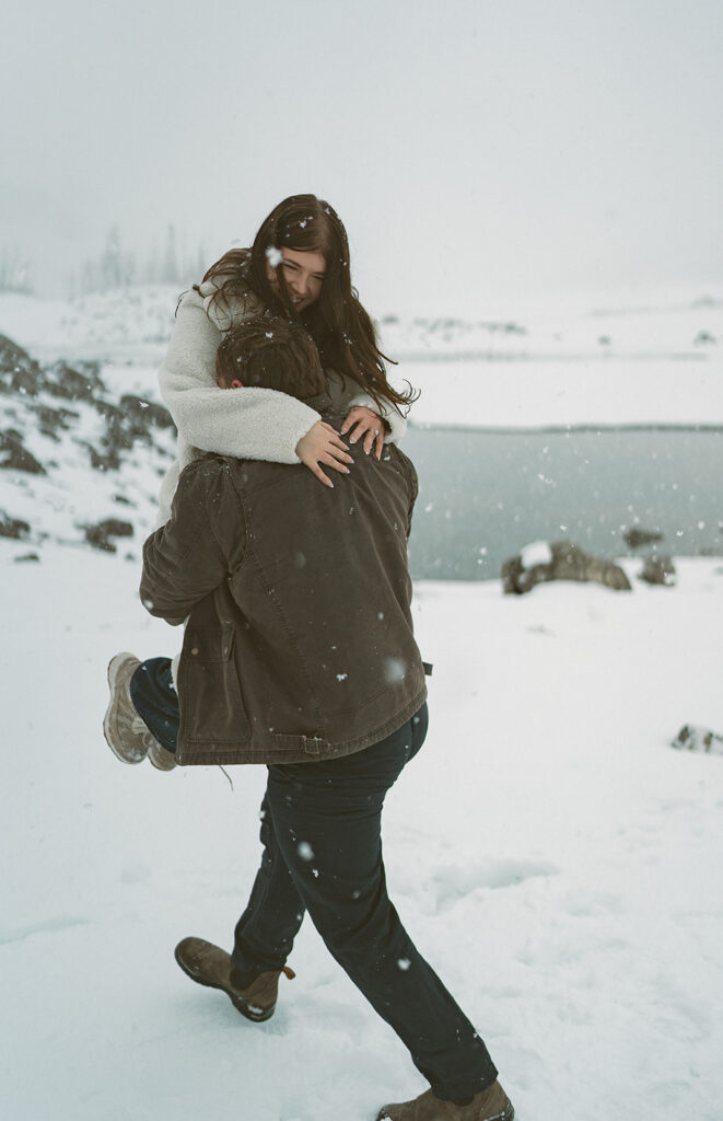 Romantic candid engagement photos in Jasper National Park snowstorm