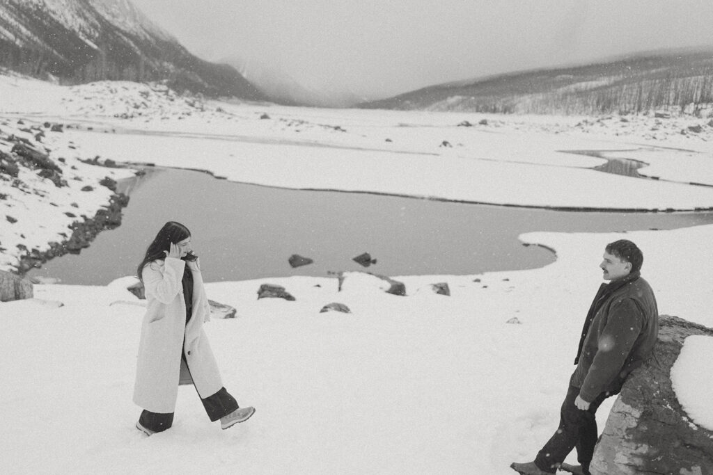 Wide view of frozen lake and mountains during Jasper engagement photos