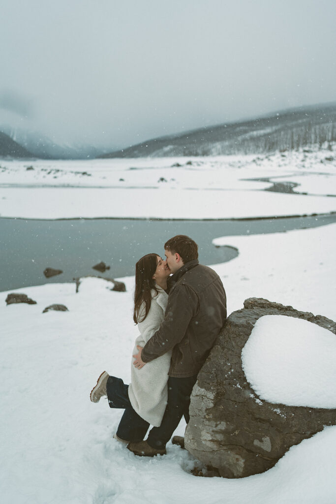 Romantic candid engagement photos in Jasper National Park snowstorm