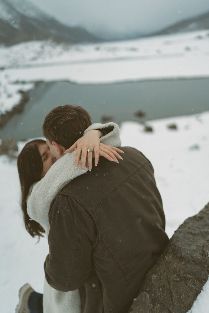 Couple kissing in snow at Medicine Lake Jasper Alberta