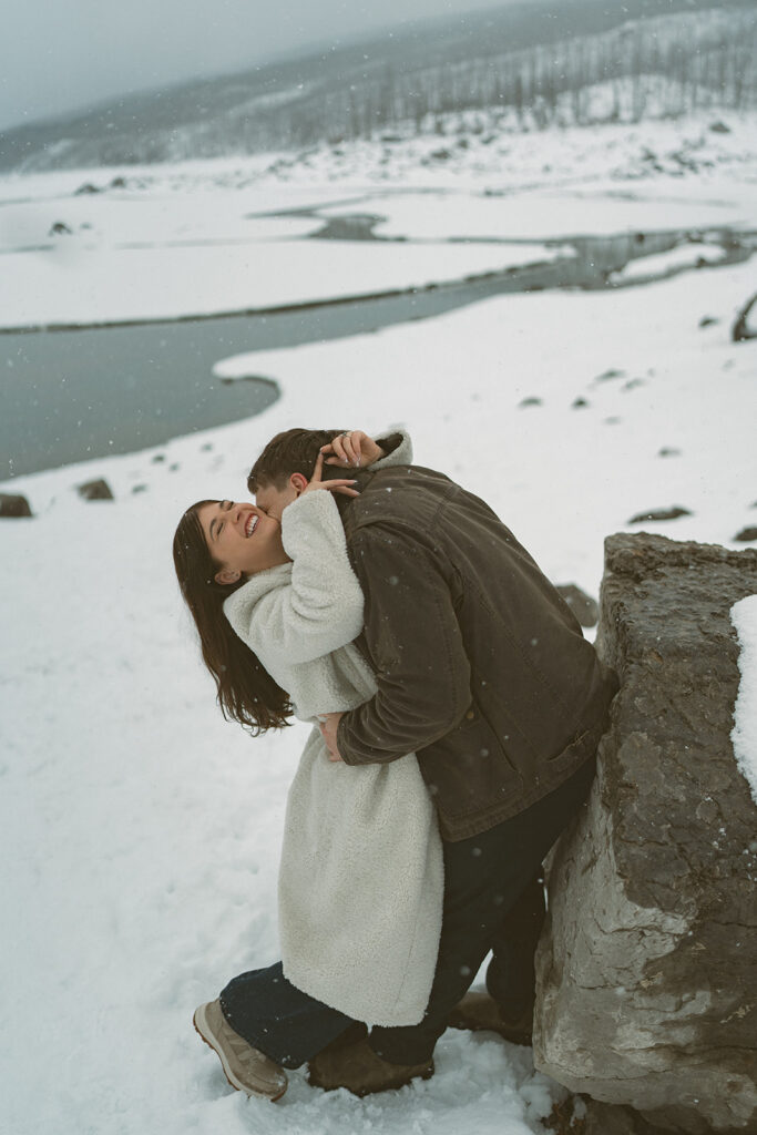 Couple kissing in snow at Medicine Lake Jasper Alberta