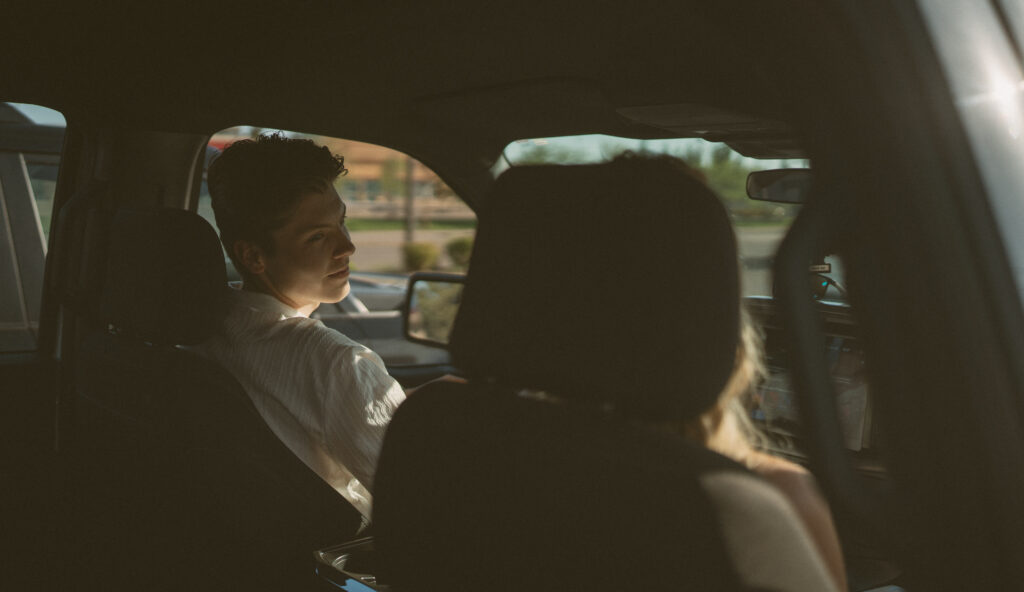 Couple sharing a quiet candid moment in a truck during a storytelling Lloydminster engagement shoot.