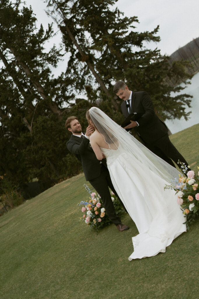 Wedding ceremony overlooking the Canadian Rockies at Fairmont Jasper Park Lodge.