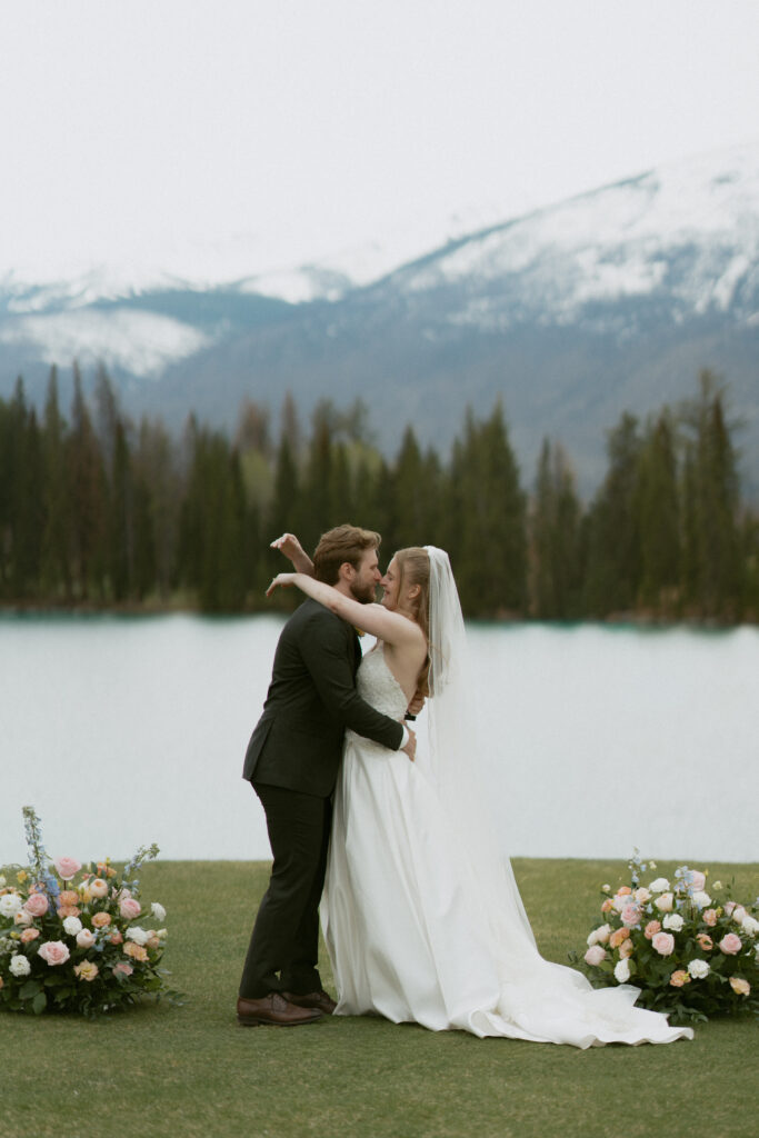 Wedding ceremony overlooking the Canadian Rockies at Fairmont Jasper Park Lodge.