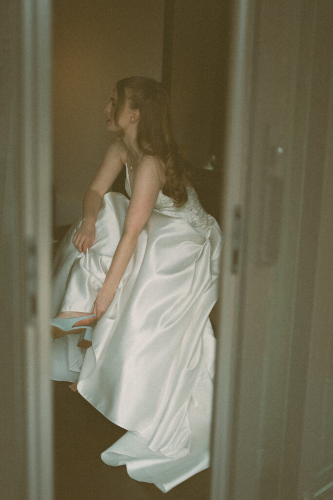 Bride and groom helping each other get ready before their Jasper National Park wedding.