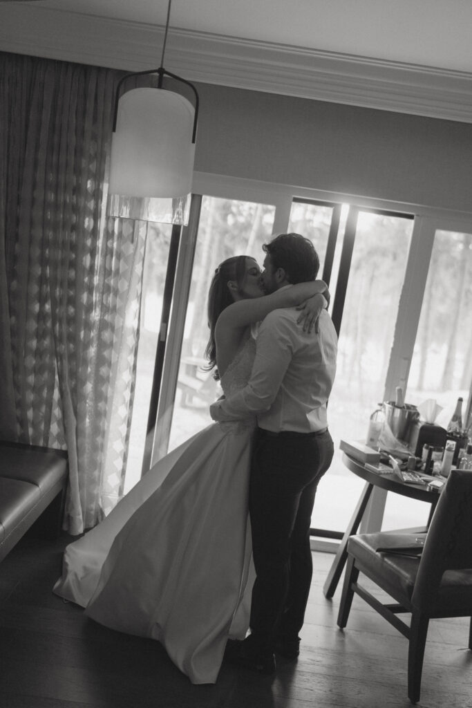 Bride and groom helping each other get ready before their Jasper National Park wedding.